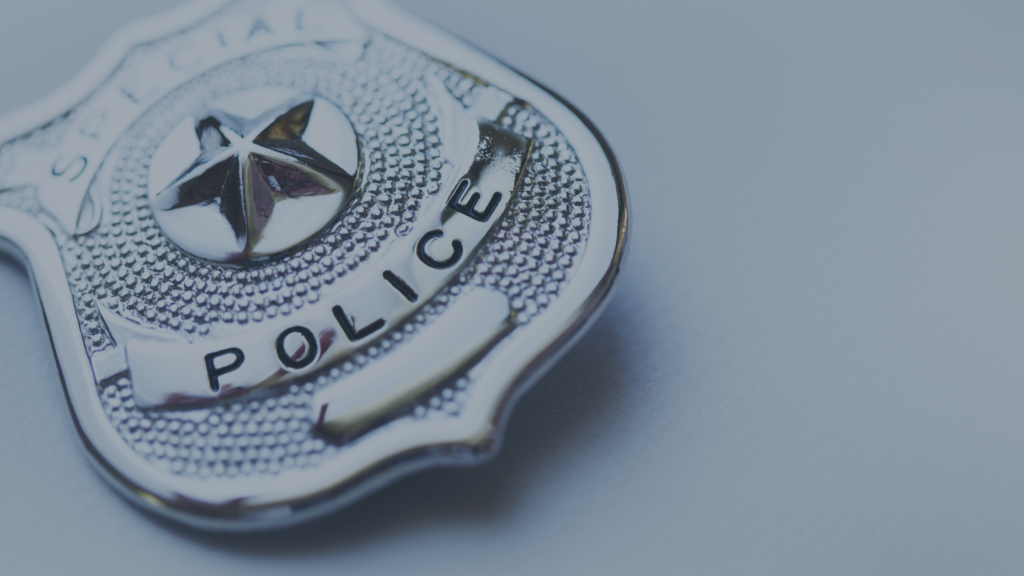 closeup of a police shield on a white background