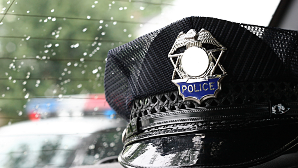 Police hat in cruiser by back window